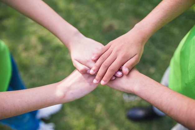 Friends stacking their hands together