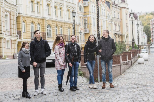 Friends standing on town street