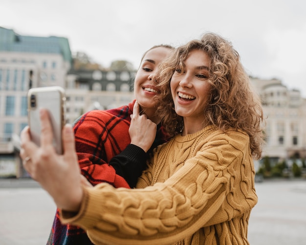 Free photo friends taking a selfie together outdoors