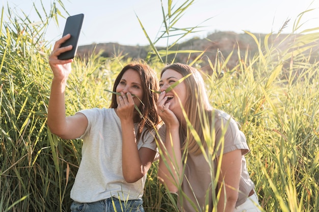 Friends taking a selfie while traveling in a wild place