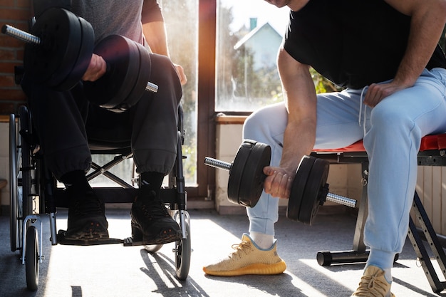 Friends training together with dumbbells