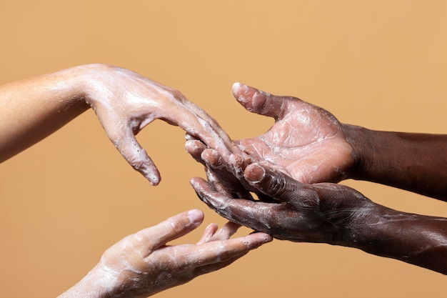 Free photo friends washing hands with soap