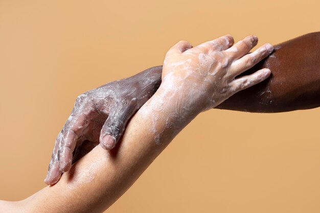 Friends washing hands with soap