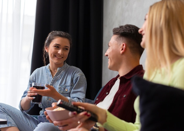 Friends watching streaming service together indoors