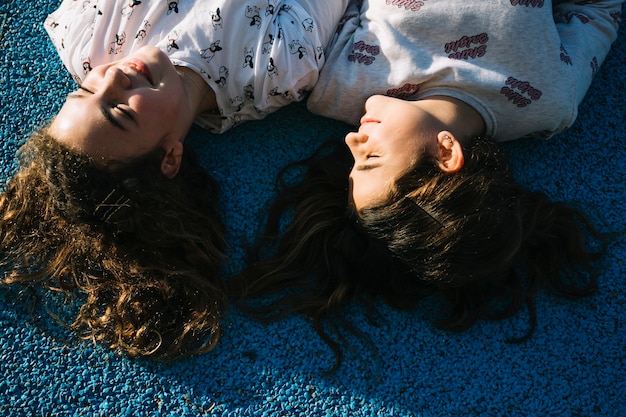 Friendship concept with girls lying down