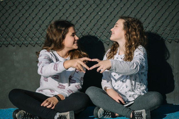 Friendship concept with girls sitting on rooftop