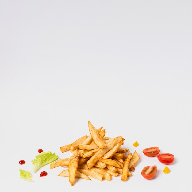 Free photo fries with tomatoes on white table