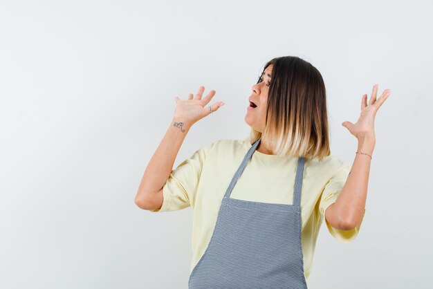 Frightening young woman looking right on white background