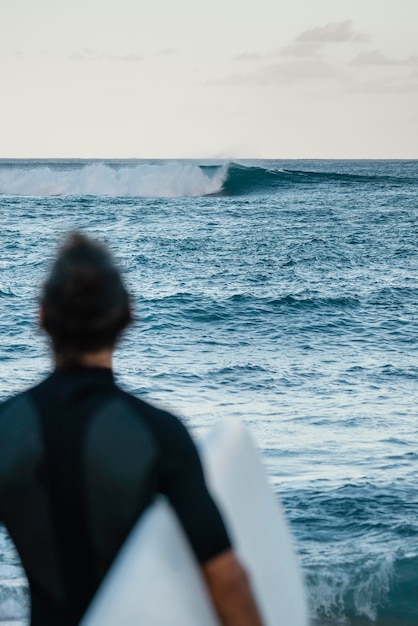 From the back shot  surfer man outdoors