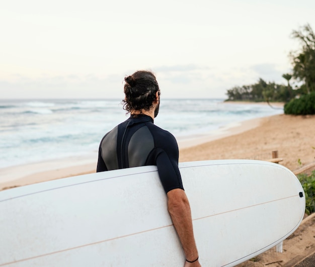 From the back shot  surfer man outdoors