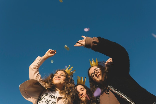 Free photo from below girls throwing confetti