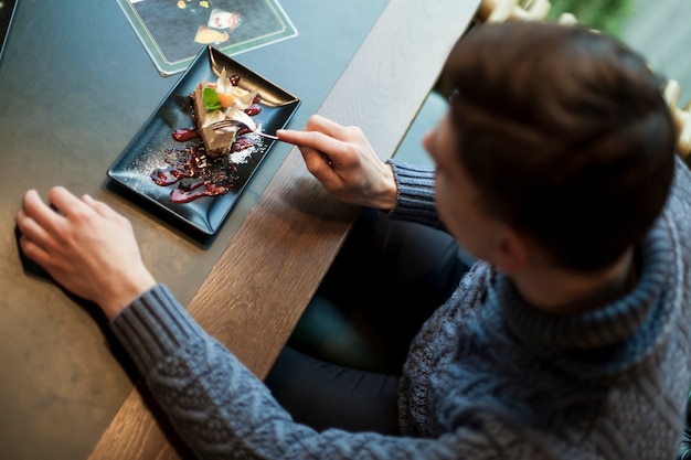 Free Photo from above man enjoying dessert in cafe