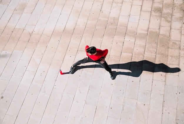 From above man lunging on pavement