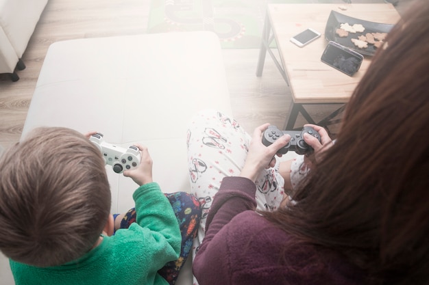 Free photo from above mother and son playing video games