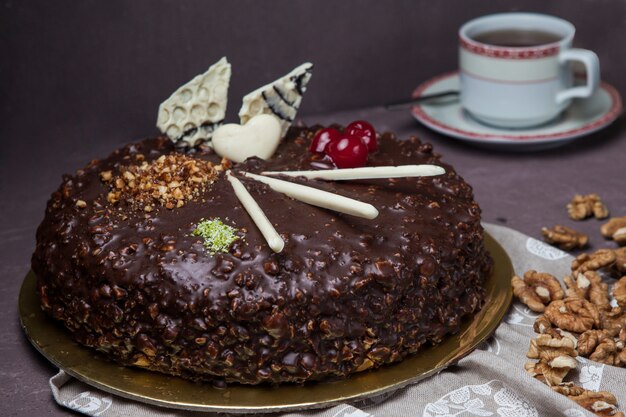 From above nut cake with walnut and cup of tea in rag