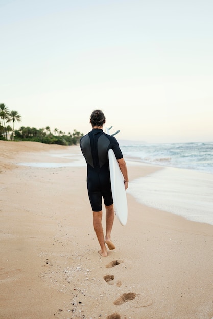 From behind shot surfer man outdoors