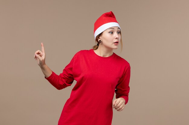 Fron view of female in red with excited face on brown