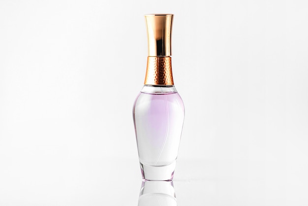 A front close up view bottle perfume transparent and bronze isolated on the white floor