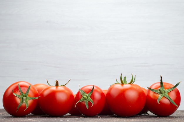 Front close view fresh red tomatoes ripe on the white background vegetable fruit color food