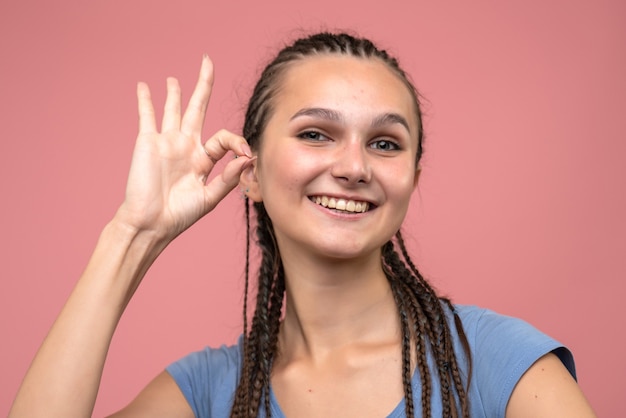 Front close view young girl with smile on pink