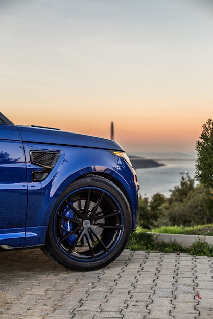 Front right wheel of a blue jeep.