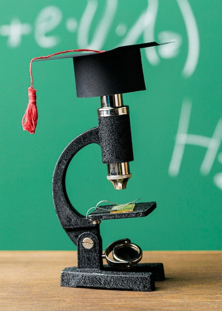 Free photo front view of academic cap on microscope