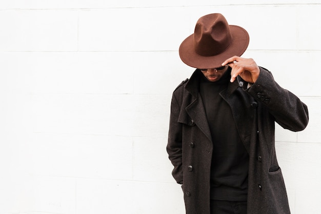 Front view adult male posing with stylish hat