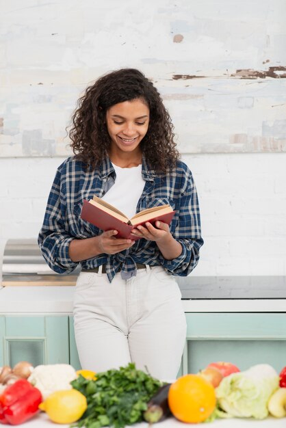 Front view afro american woman reading a book