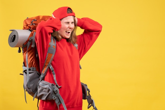 Free photo front view angry traveller woman in red backpack holding head screaming