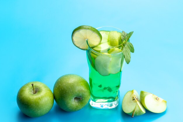 A front view apple cocktail fresh and cooling along with fresh apples and lemon slices on blue, fresh drink fruit juice