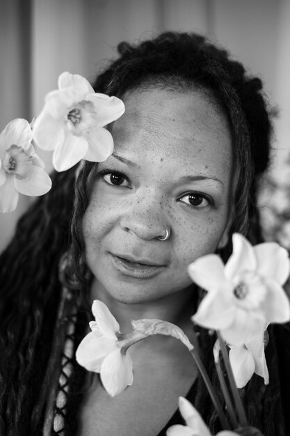 Front view authentic woman posing with flowers