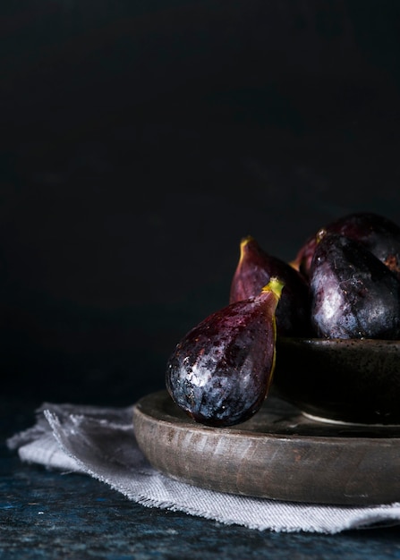 Free photo front view of autumn figs on plate with copy space