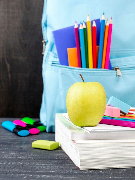 Front view of back to school stationery with apple and colorful pencils