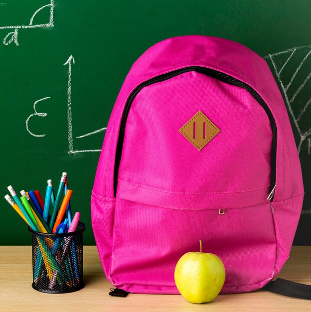 Free Photo front view of backpack for back to school with apple and pencils