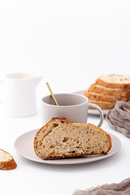 Front view baked bread and cup of coffee