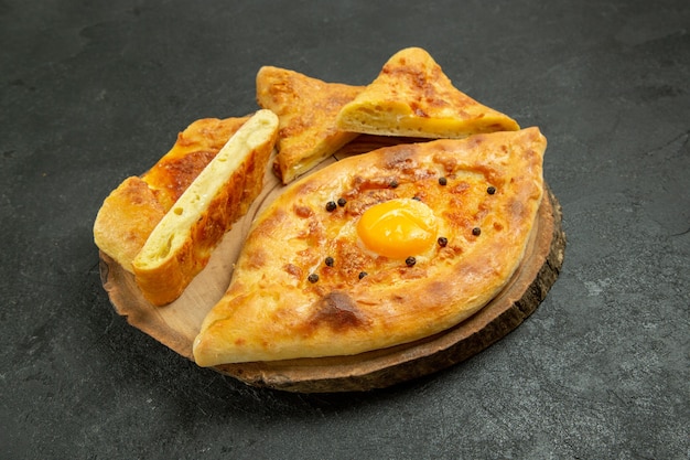 Front view baked egg bread delicious fresh off the oven on the dark grey space