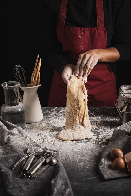 Front view baker mixing dough composition 