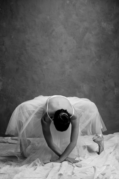 Front view ballerina bending in pointe shoes