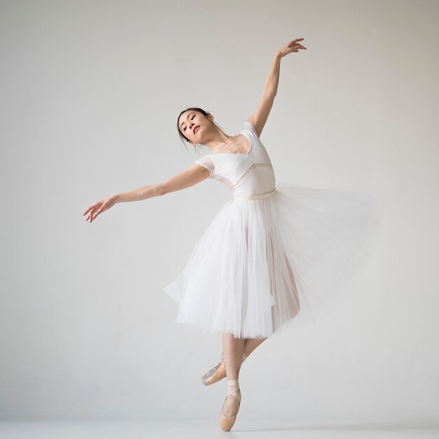 Front view of ballerina dancing in tutu dress