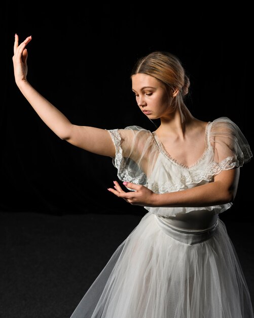 Front view of ballerina posing in tutu dress