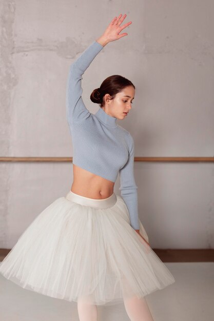 Front view of ballerina in tutu skirt practicing ballet