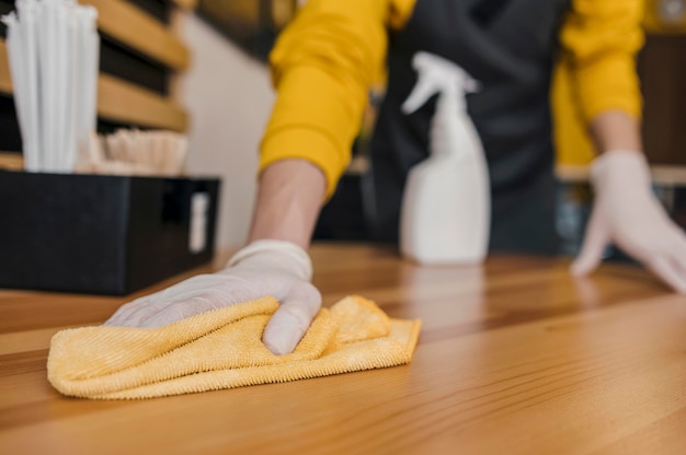 Free photo front view of barista cleaning table