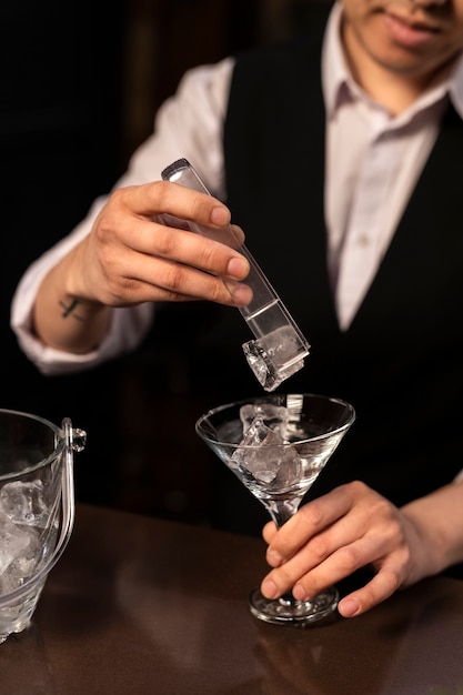 Free Photo front view bartender preparing drink