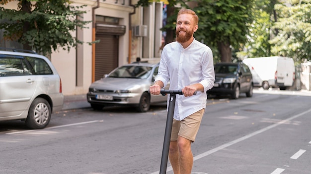 Front view bearded modern man on scooter outside