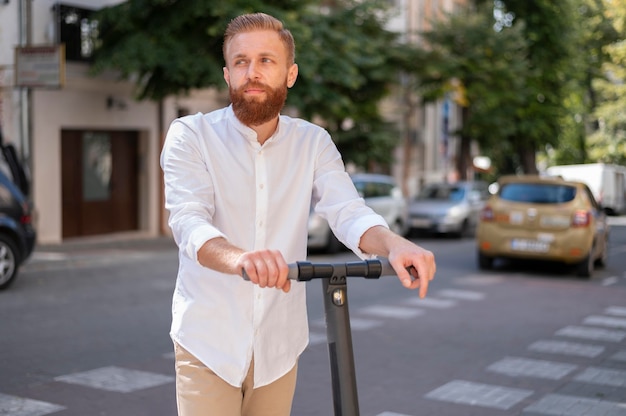 Front view bearded modern man on scooter