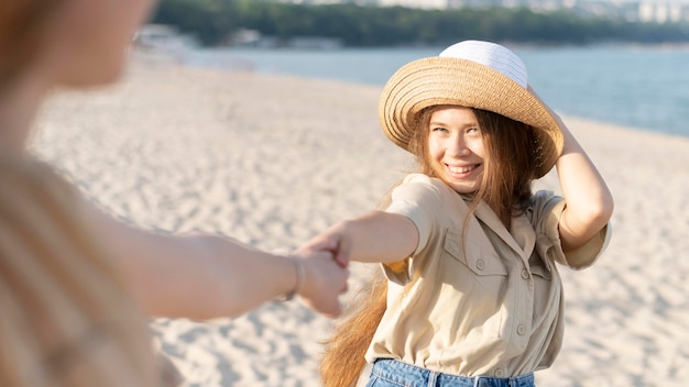 Free Photo front view of beautiful girls at beach