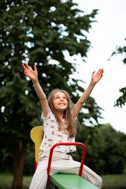 Free photo front view of beautiful happy girl in park