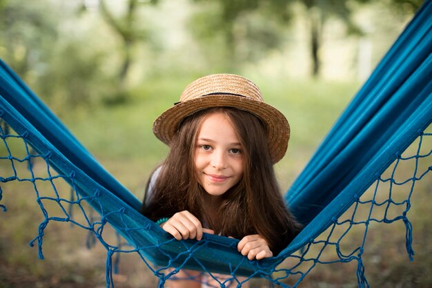 Front view of beautiful smiling girl in hammock