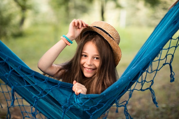 Front view of beautiful smiling girl in hammock