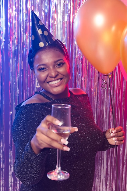 Front view beautiful woman holding a glass of champagne